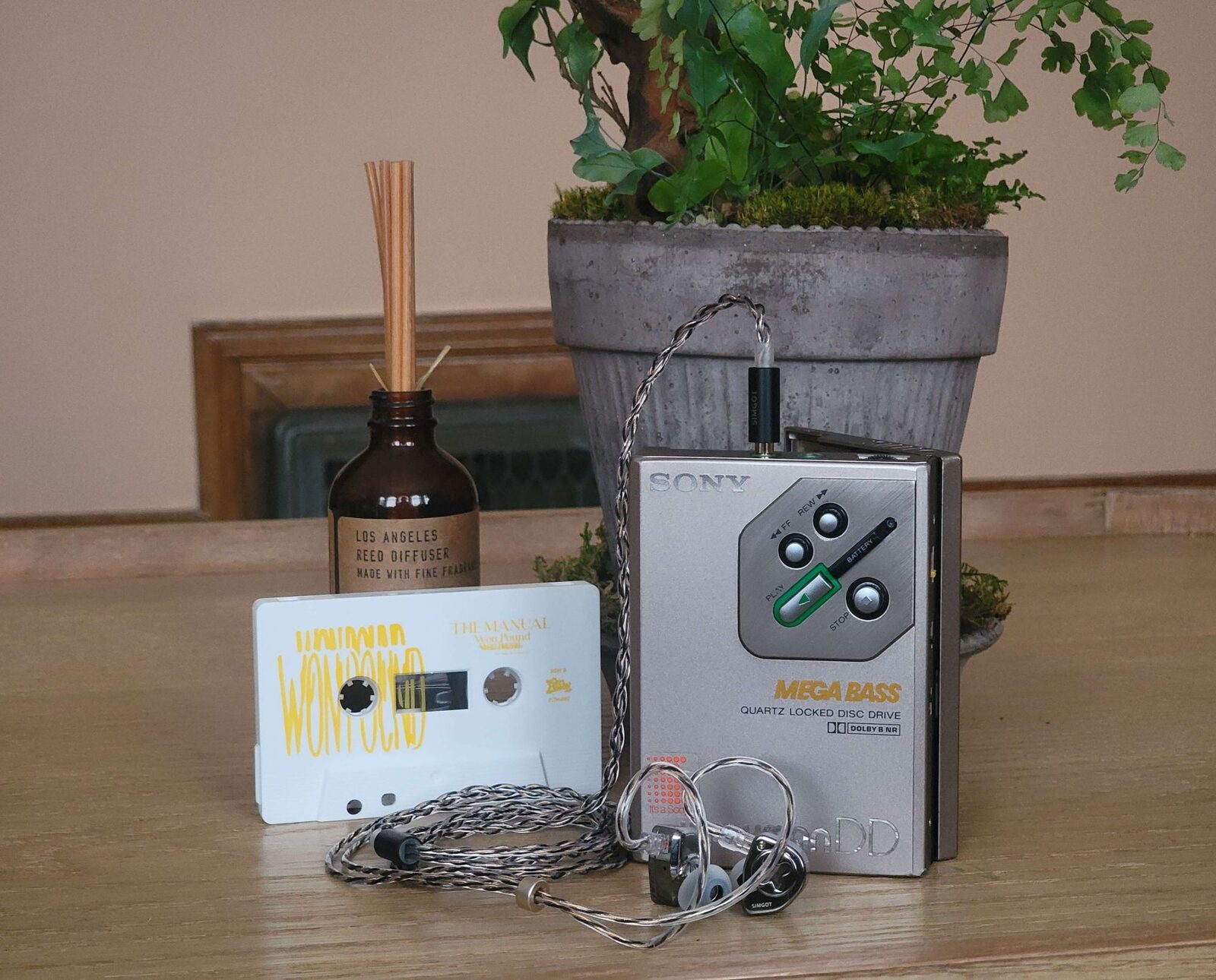 A restored silver Sony MEGA BASS DD Walkman playing, with earphones